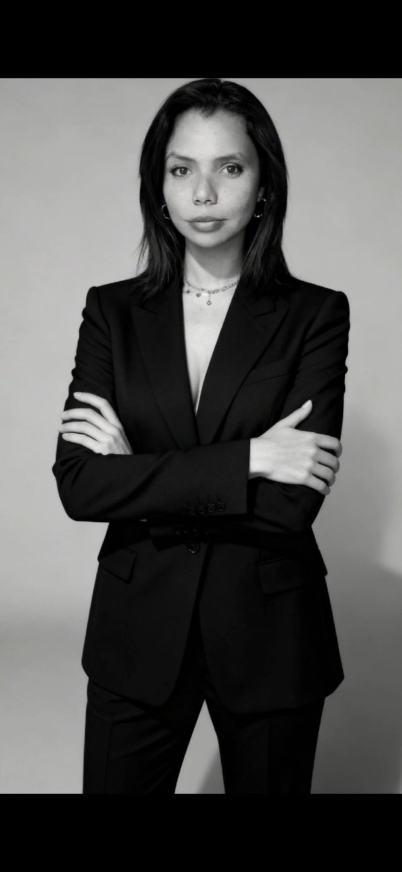 Black and white photo of Cate in a business suit 
